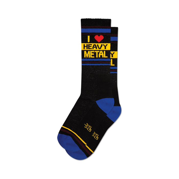 a pair of black socks with yellow and blue stripes at the top. the words 'i heart heavy metal' are written vertically in yellow letters with a red heart in the word 'heart'. }}