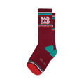 Pair of maroon crew socks with teal accents and a retro-style 'Rad Dad' graphic. 