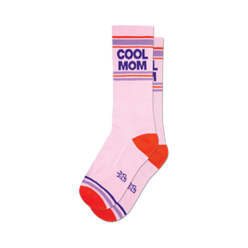 a pair of socks that are  white with the words 'cool mom' in black and purple block letters. the socks have an orange toe, heel, and cuff with two purple stripes.