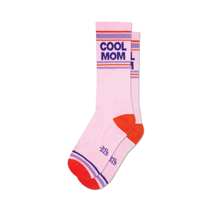 a pair of socks that are  white with the words 'cool mom' in black and purple block letters. the socks have an orange toe, heel, and cuff with two purple stripes. }}