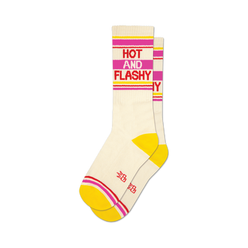 a pair of socks with the words 'hot and flashy' on them. socks that are white with yellow toes and heels and red and pink stripes at the top.