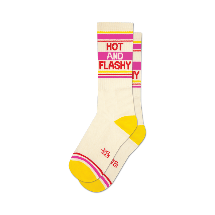 a pair of socks with the words 'hot and flashy' on them. socks that are white with yellow toes and heels and red and pink stripes at the top. }}