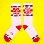 Another flat lay of the socks, slightly spread apart, on a yellow background. [lf]