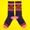 Another flat lay showcasing the 'Big City Energy' socks, this time laid out in a more spread-out manner on a yellow background. [lf]
