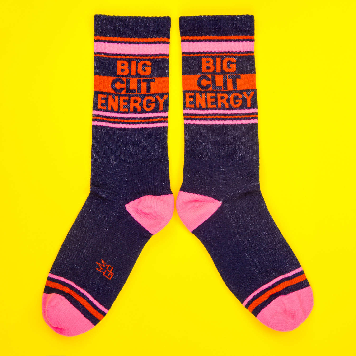 Another flat lay showcasing the 'Big City Energy' socks, this time laid out in a more spread-out manner on a yellow background. [lf]