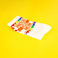 Close-up of folded 'Proud Gay Mom' socks on a yellow background. [lf]