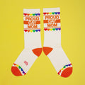 Lifestyle shot of 'Proud Gay Mom' socks on a foot (possibly a model). [lf]
