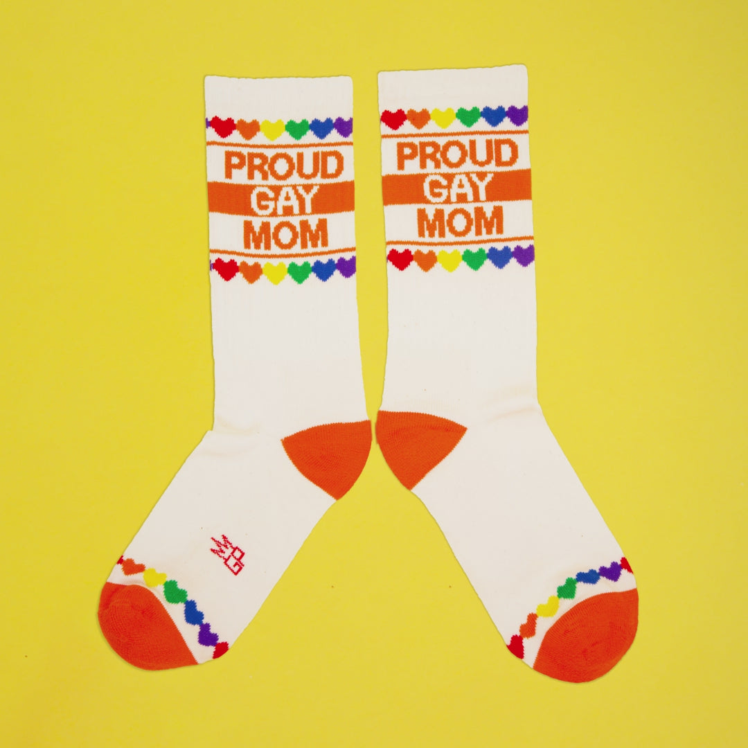 Lifestyle shot of 'Proud Gay Mom' socks on a foot (possibly a model). [lf]