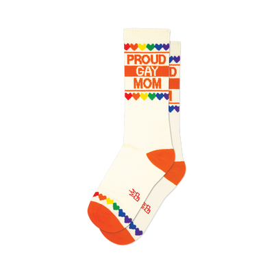 front view of two white socks with orange trim, "proud gay mom" in orange text, a rainbow heart border, and rainbow heart cuff.