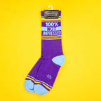 Single purple '100% Not Impressed' sock on a yellow background; hanging on a Gumball Poodle tag. [lf]