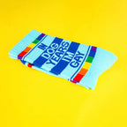Folded 'In Dog Years I'm Gay' socks displayed on a yellow background. [lf]