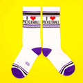 Another flatlay showing both socks, on a yellow background.