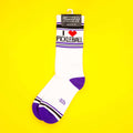'I Heart Pickleball' socks on yellow background, hanging on display card.