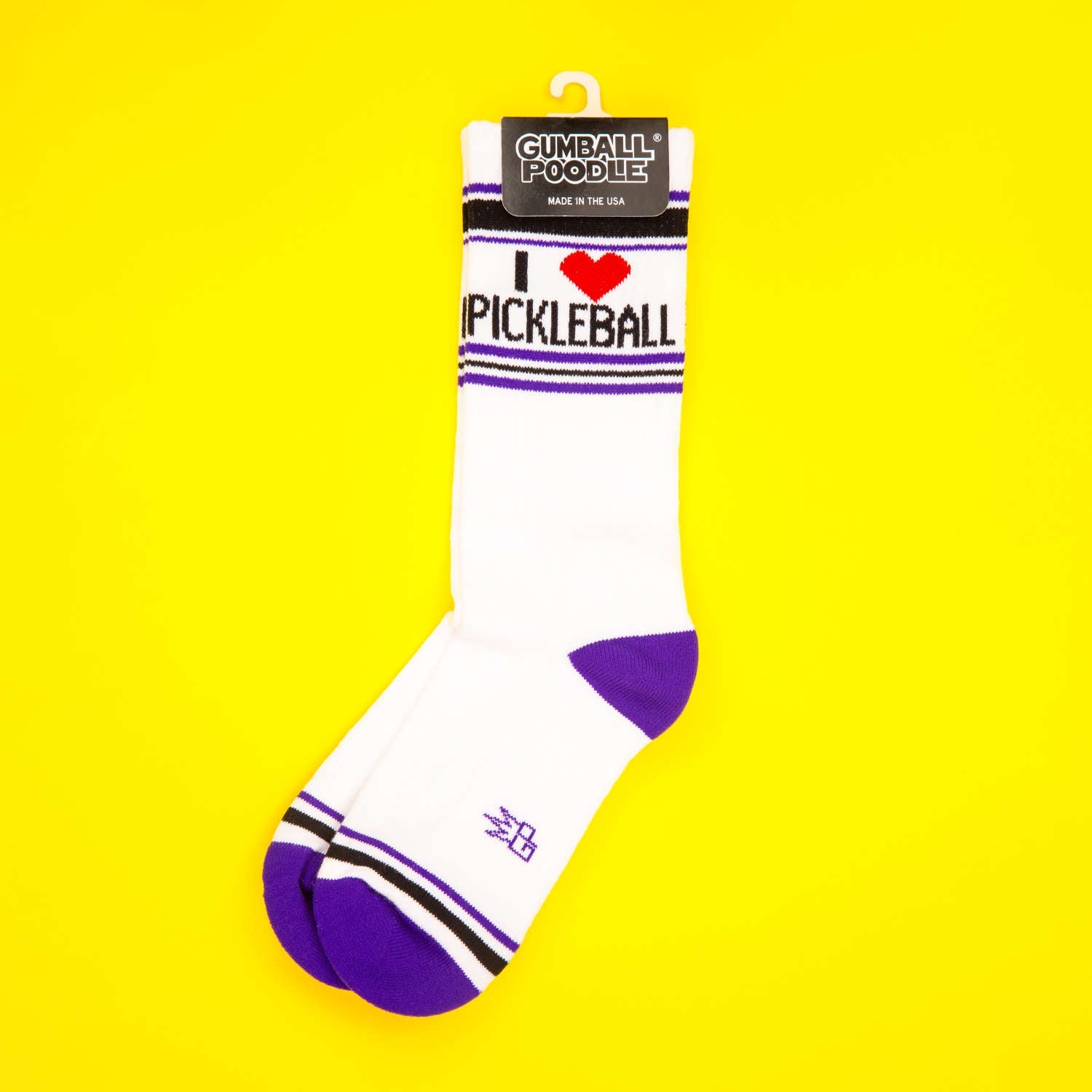 'I Heart Pickleball' socks on yellow background, hanging on display card.