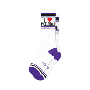 front view of white socks with purple, black and red stripes that say 'i love pickleball' with a red heart.