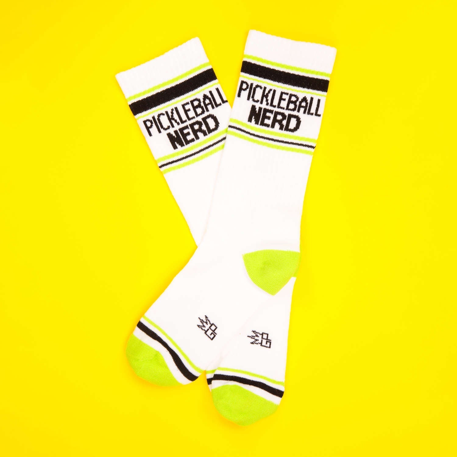Two Pickleball Nerd socks on a yellow background. [lf]