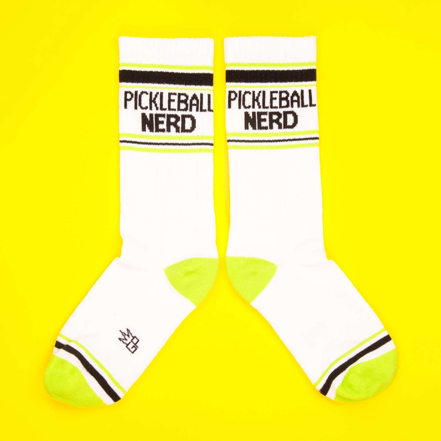 Pair of Pickleball Nerd socks displayed flat on a yellow background. [lf]