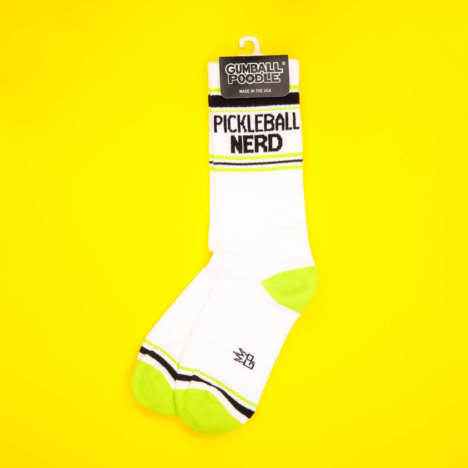 Single Pickleball Nerd sock folded on a yellow background. [lf]