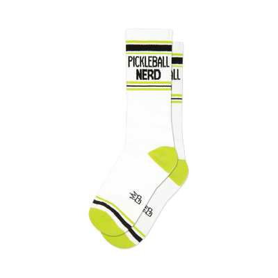 front view of a pair of white athletic socks with black and lime green stripes and the words "pickleball nerd" in black.