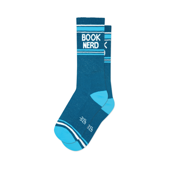 a close-up view of a pair of blue and white socks that say 'book nerd'.