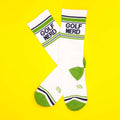 Flatlay image of Golf Nerd socks on a yellow background. [lf]