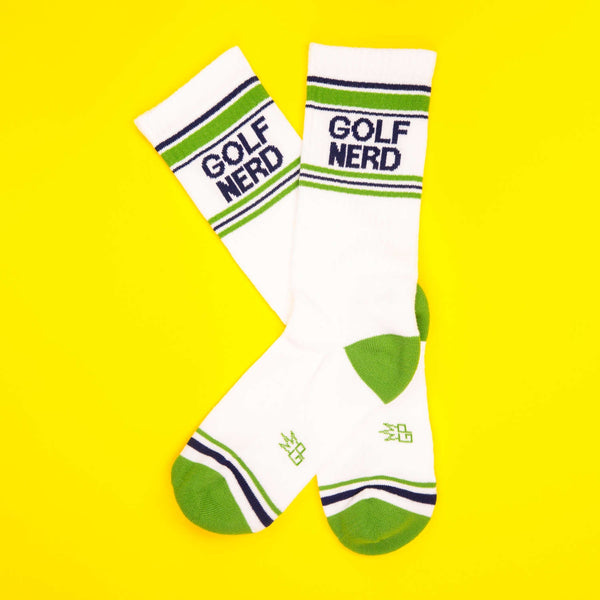 Flatlay image of Golf Nerd socks on a yellow background. [lf]