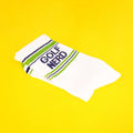 Close-up of Golf Nerd socks folded on a yellow background. [lf]