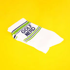 Close-up of Golf Nerd socks folded on a yellow background. [lf]