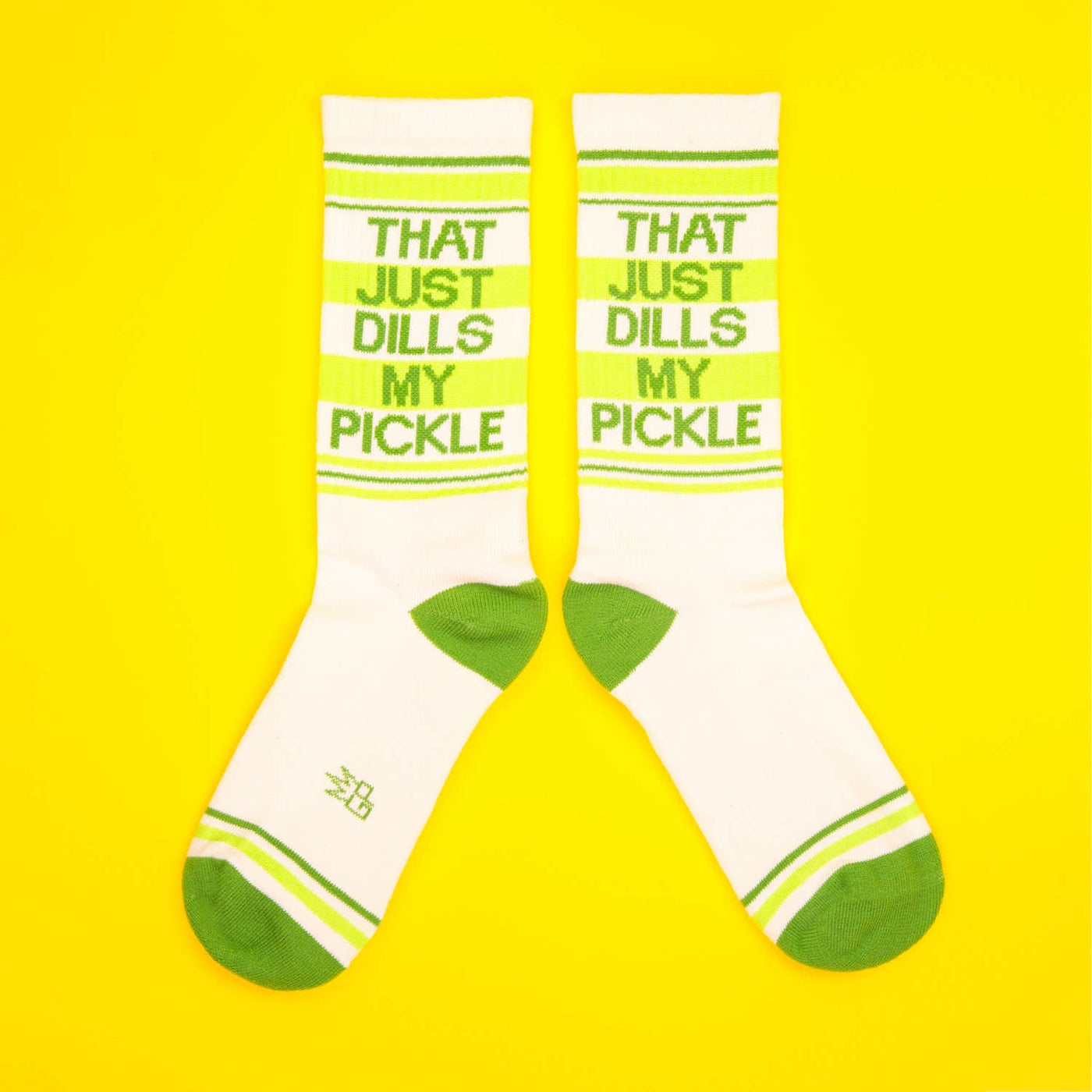Another flat lay of the socks, showcasing the full design on a bright yellow background. [lf]