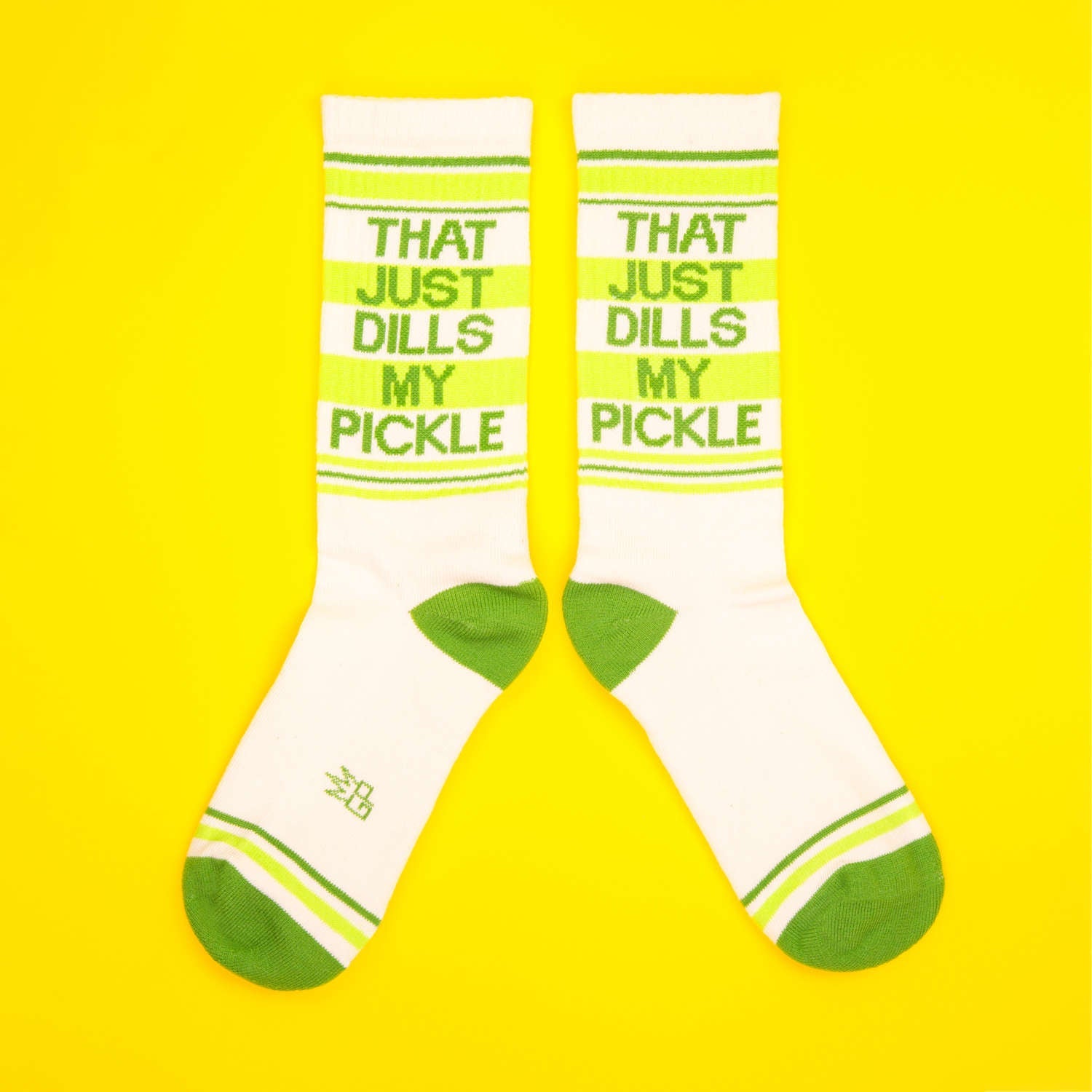 Another flat lay of the socks, showcasing the full design on a bright yellow background. [lf]