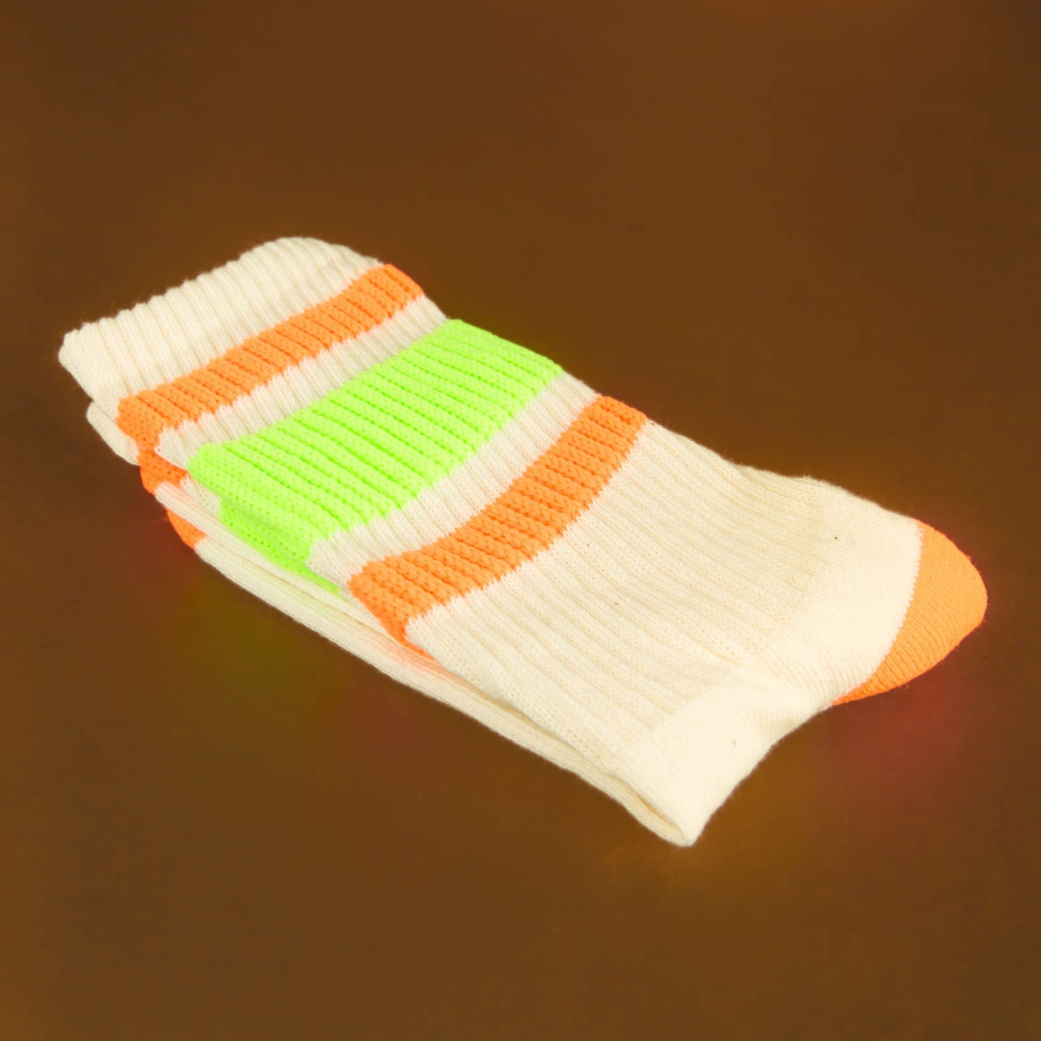 Close-up shot of Bobby socks folded neatly, highlighting the texture and vibrant stripes. [lf]