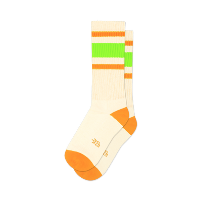 front view of a pair of white socks with neon green and orange stripes.