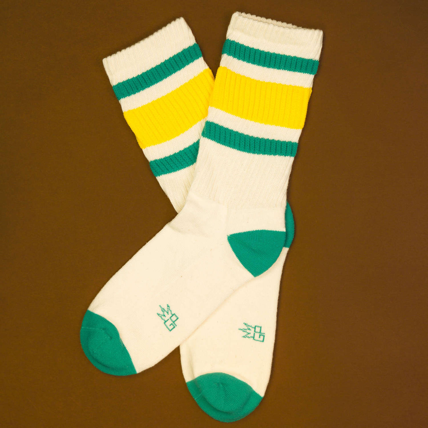 Flat lay of Carol socks on a brown surface. [lf]