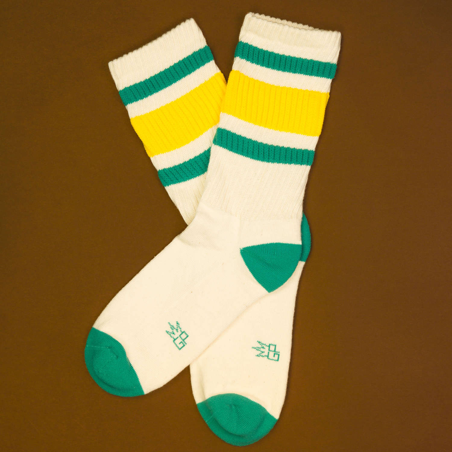 Flat lay of Carol socks on a brown surface. [lf]