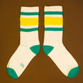Another flat lay of Carol socks, slightly offset, on a brown background. [lf]