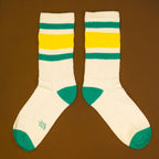Another flat lay of Carol socks, slightly offset, on a brown background. [lf]