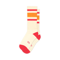 Pair of off-white crew socks with pink and orange stripes. Red accents at the heel and toe. A small logo is visible on the sole.