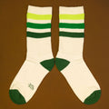 Flat lay product shot of Greg socks on a brown background, showing the socks laid out. [lf]