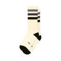 Pair of off-white crew socks with black and grey horizontal stripes. Black cuffs and subtle embroidered logo.