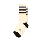 Pair of off-white crew socks with black and grey horizontal stripes. Black cuffs and subtle embroidered logo.