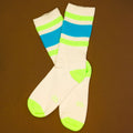 Flat lay product shot of Peter socks on a brown background. [lf]