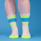Product shot of a single Peter sock folded on a brown surface. [lf]
