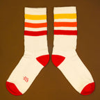 Flat lay: Tiger socks laid flat, separated, on a brown background. [lf]