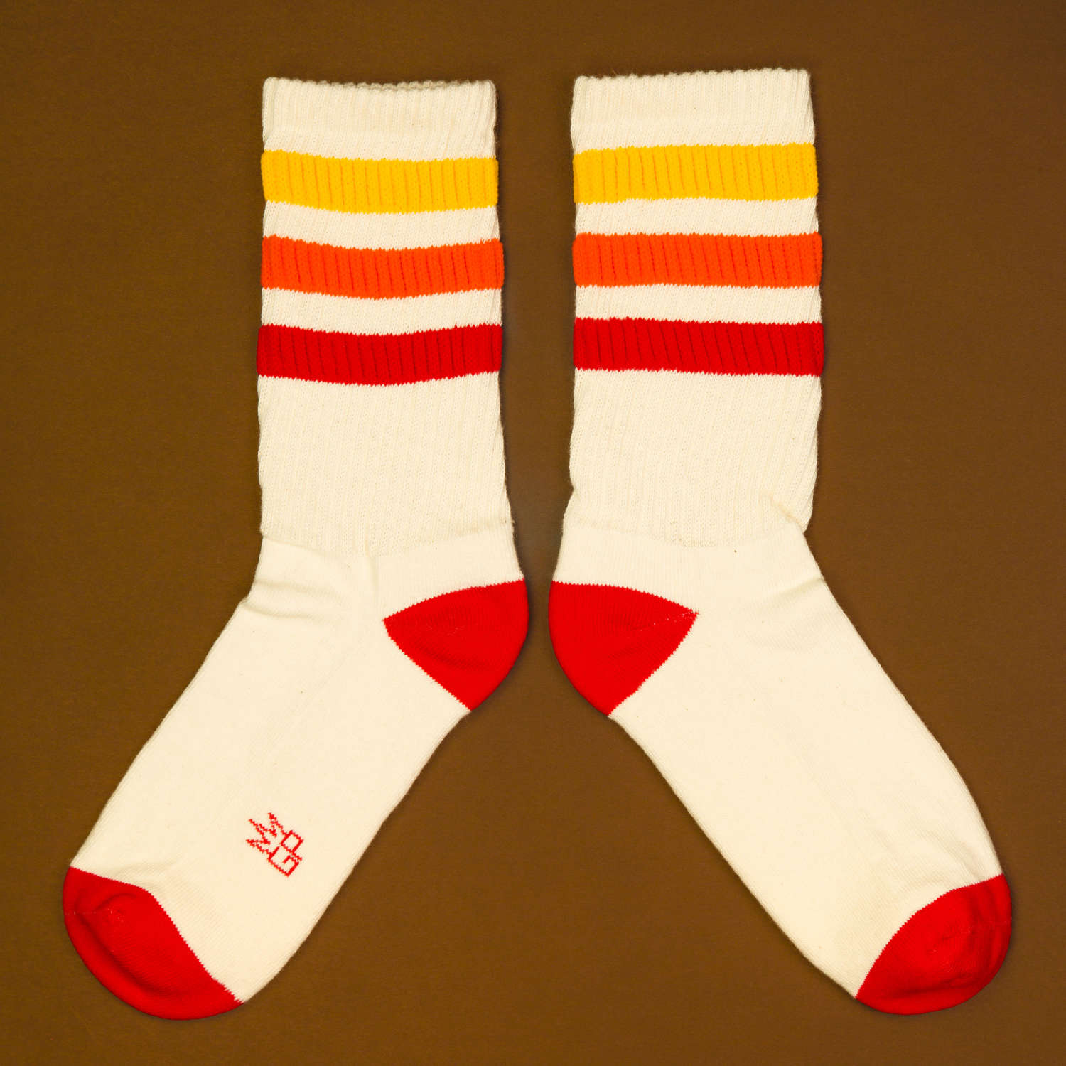 Flat lay: Tiger socks laid flat, separated, on a brown background. [lf]