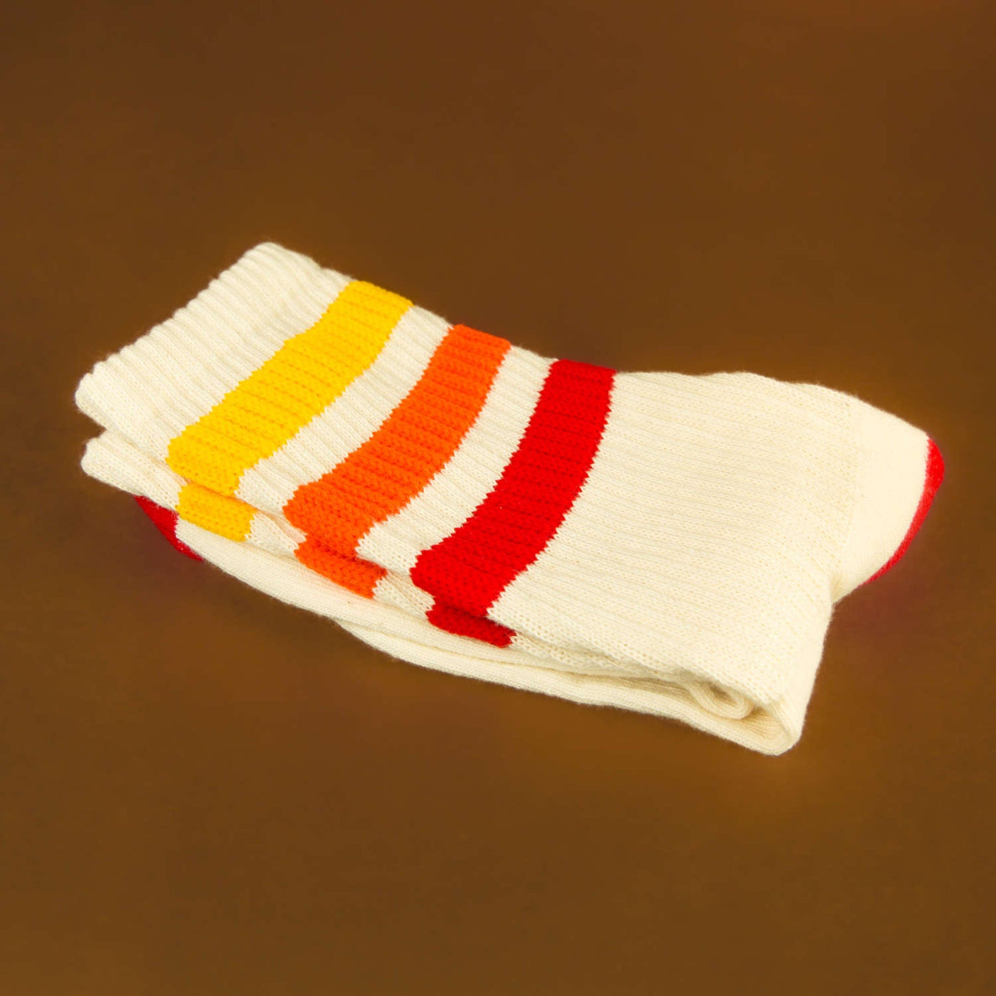 Folded Tiger socks on brown background. [lf]
