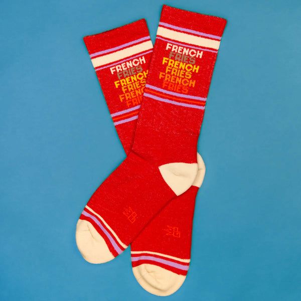 Flatlay image of two 'French Fries' socks on a blue background. [lf]