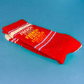 Close-up of a folded 'French Fries' sock on a blue background, showcasing the design details. [lf]
