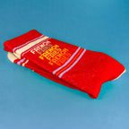 Close-up of a folded 'French Fries' sock on a blue background, showcasing the design details. [lf]
