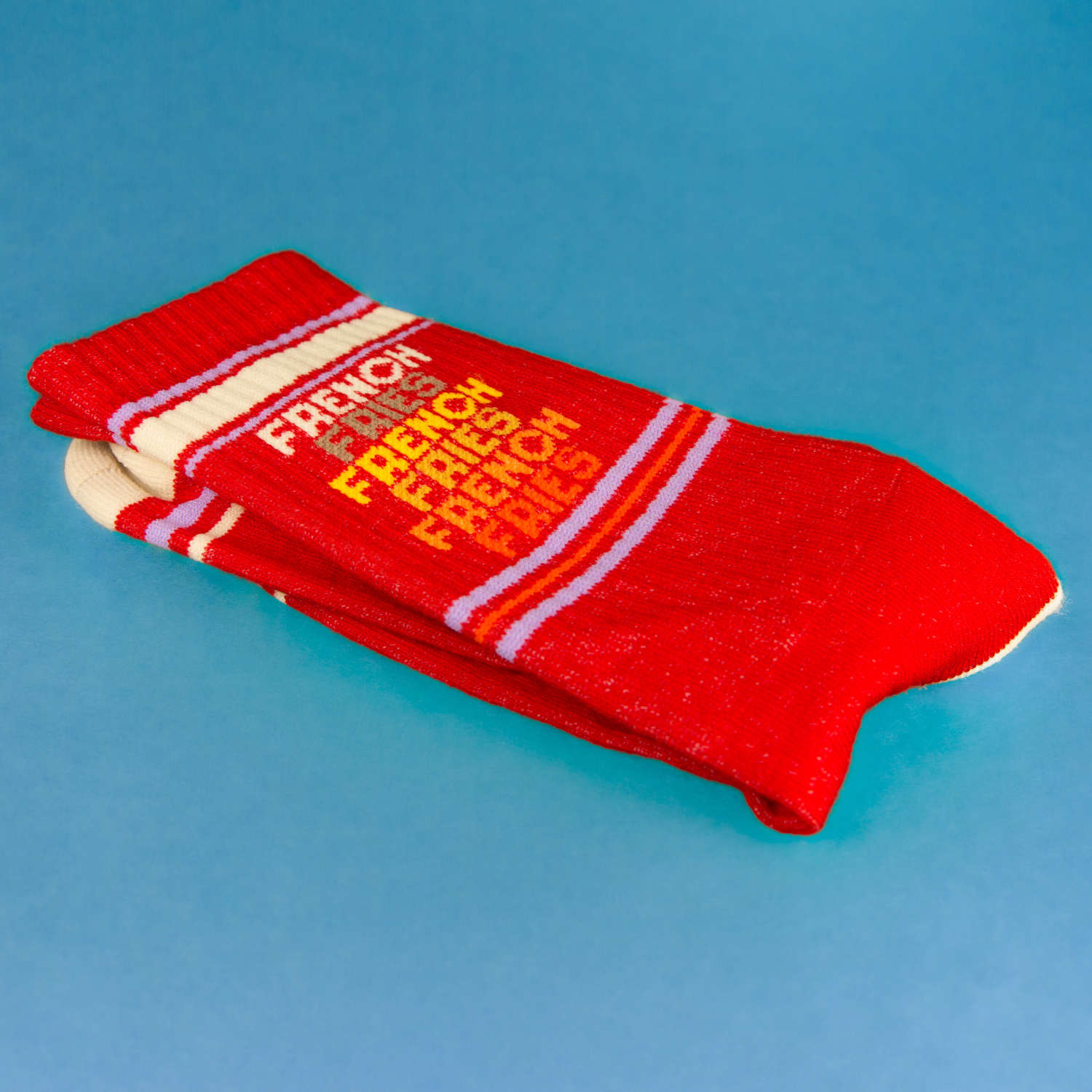 Close-up of a folded 'French Fries' sock on a blue background, showcasing the design details. [lf]