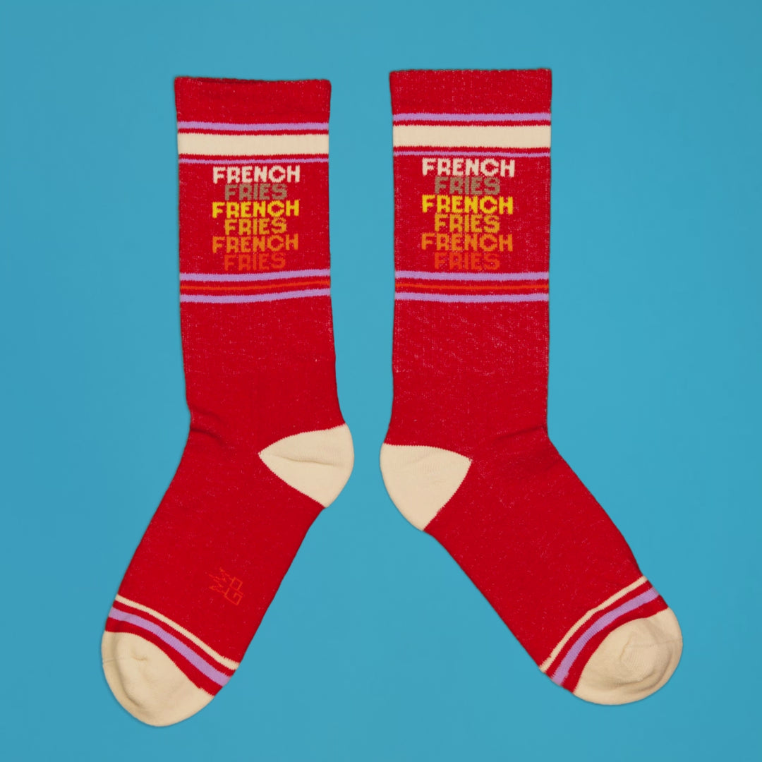 Another flatlay product shot of two 'French Fries' socks on a bright blue background. [lf]